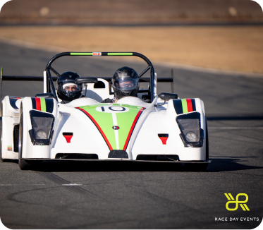 2 people on the track in a racing car