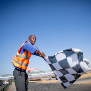 A track official waving a finishing flag